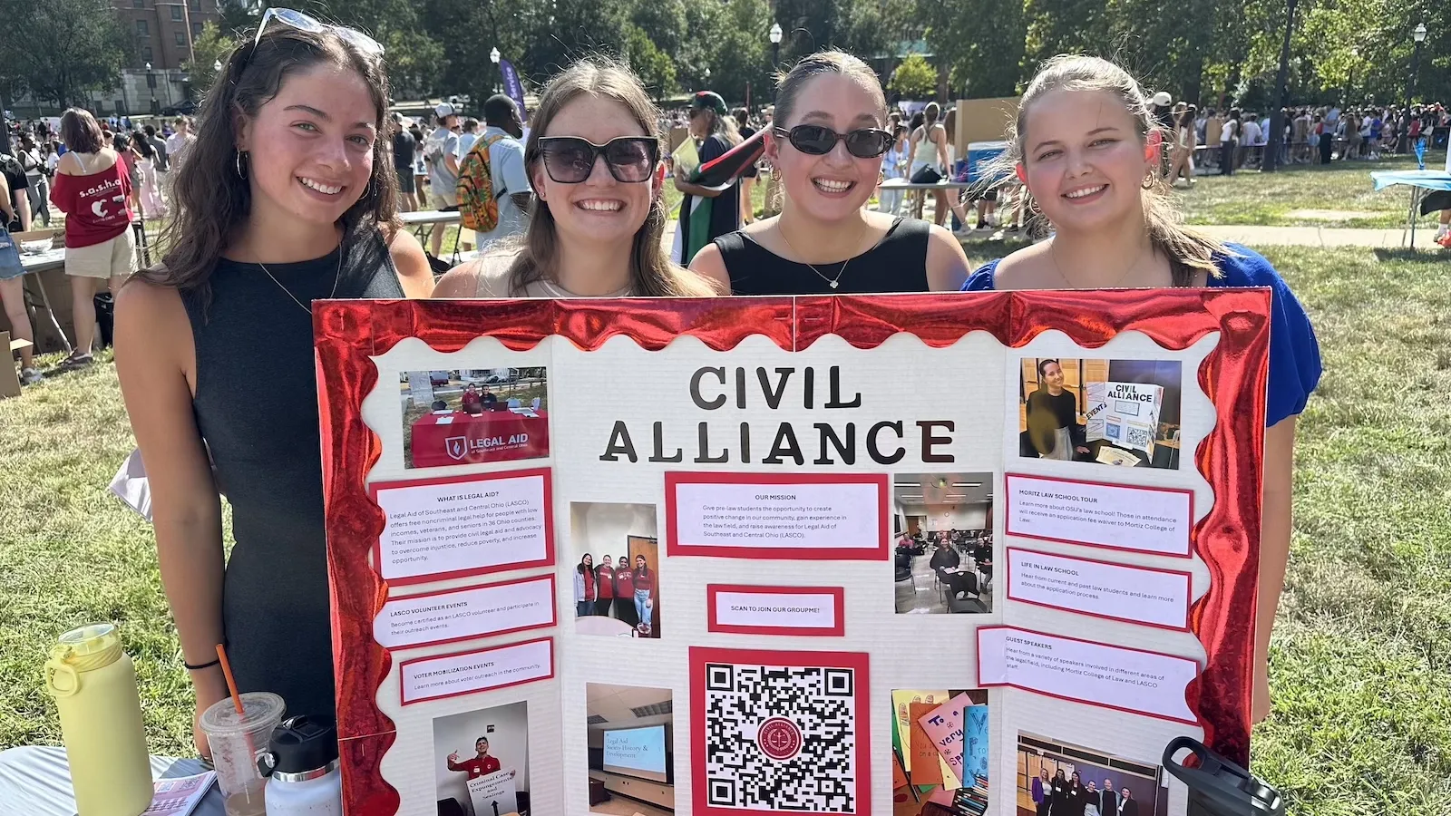 4 students behind a display poster